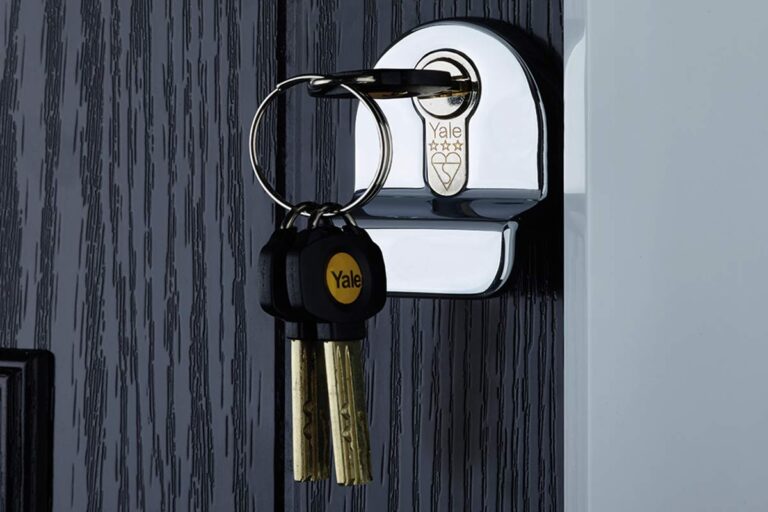 High-security deadbolt lock being installed on a wooden front door.